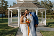 Bride and Groom Kissing in Front of Gazebo