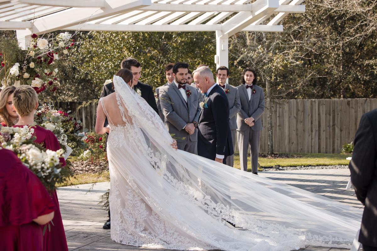 Father Walks Bride up to Groom Under Pergola